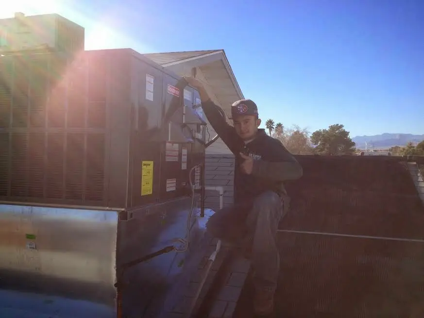HVAC technician performing HVAC Inspection on a rooftop unit in Sachse